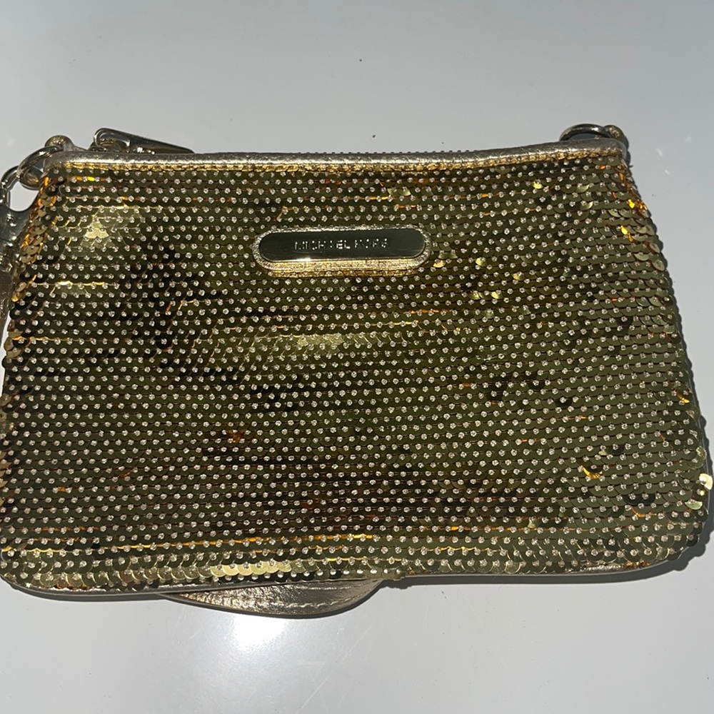 Gold Michael Kor’s wristlet.